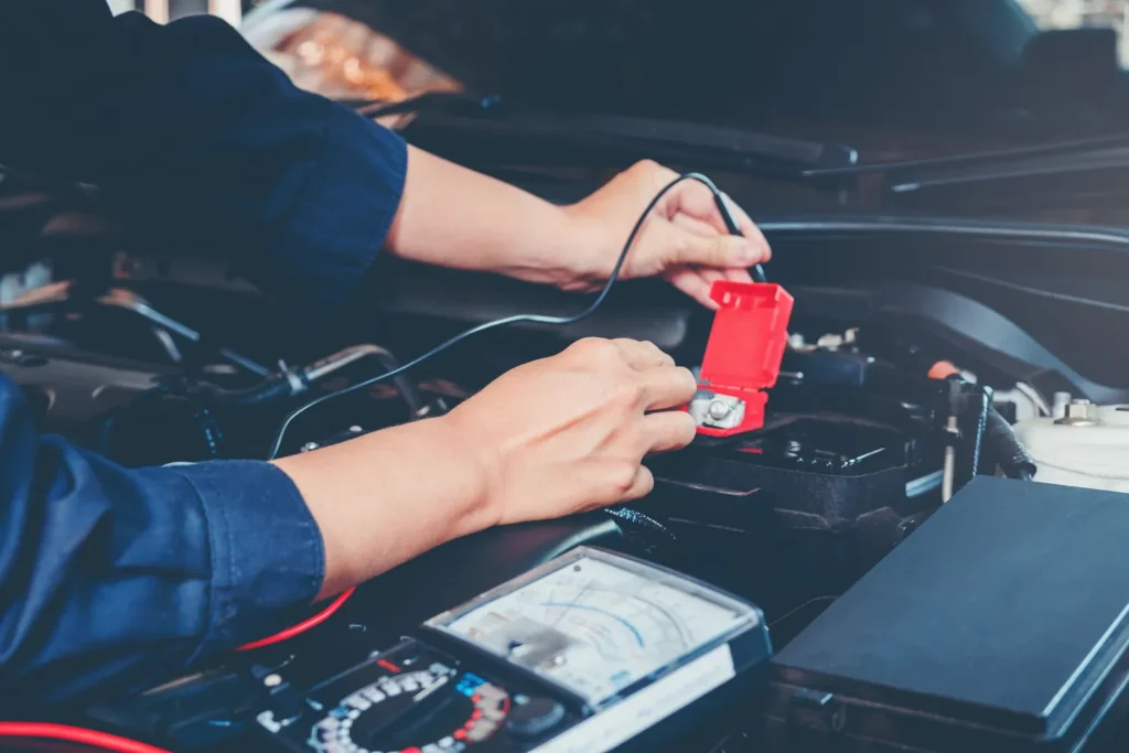 mechanic hands working in a car checking electric issues