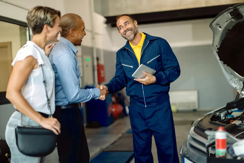 Happy mechanic greeting his customers